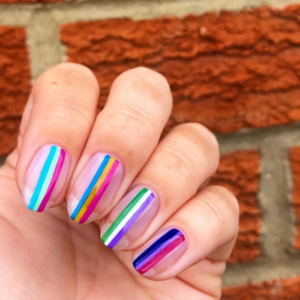 Colored design on clear nails.