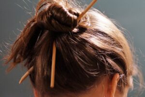 Woman with chop sticks in hair. 