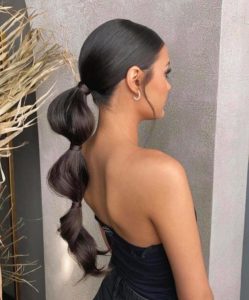 Black, low ponytail with sections. 